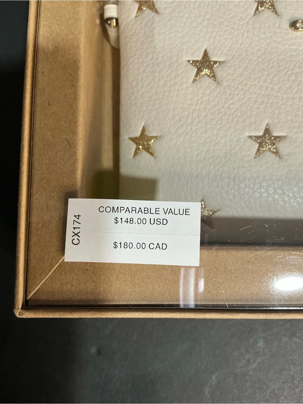 The Coach Boxed Corner Zip Wristlet With Star Print And Charms